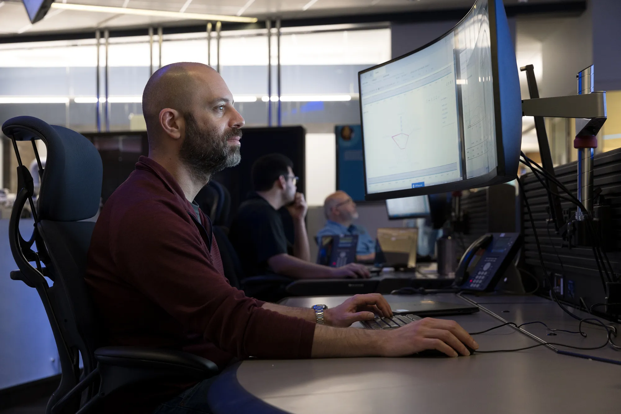 A man sitting at a desk working on a computer