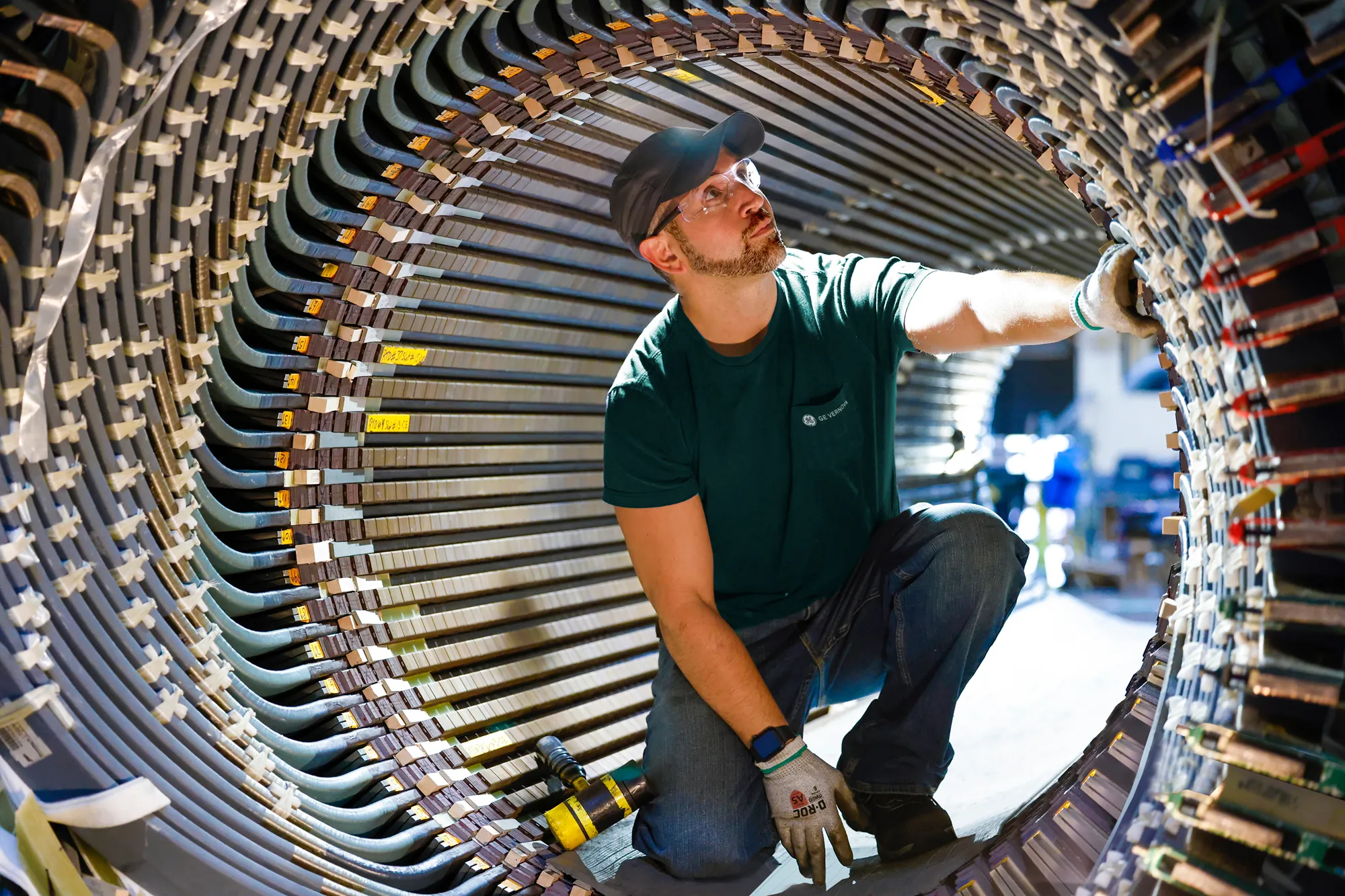A photo of a man working inside a large piece of machinery