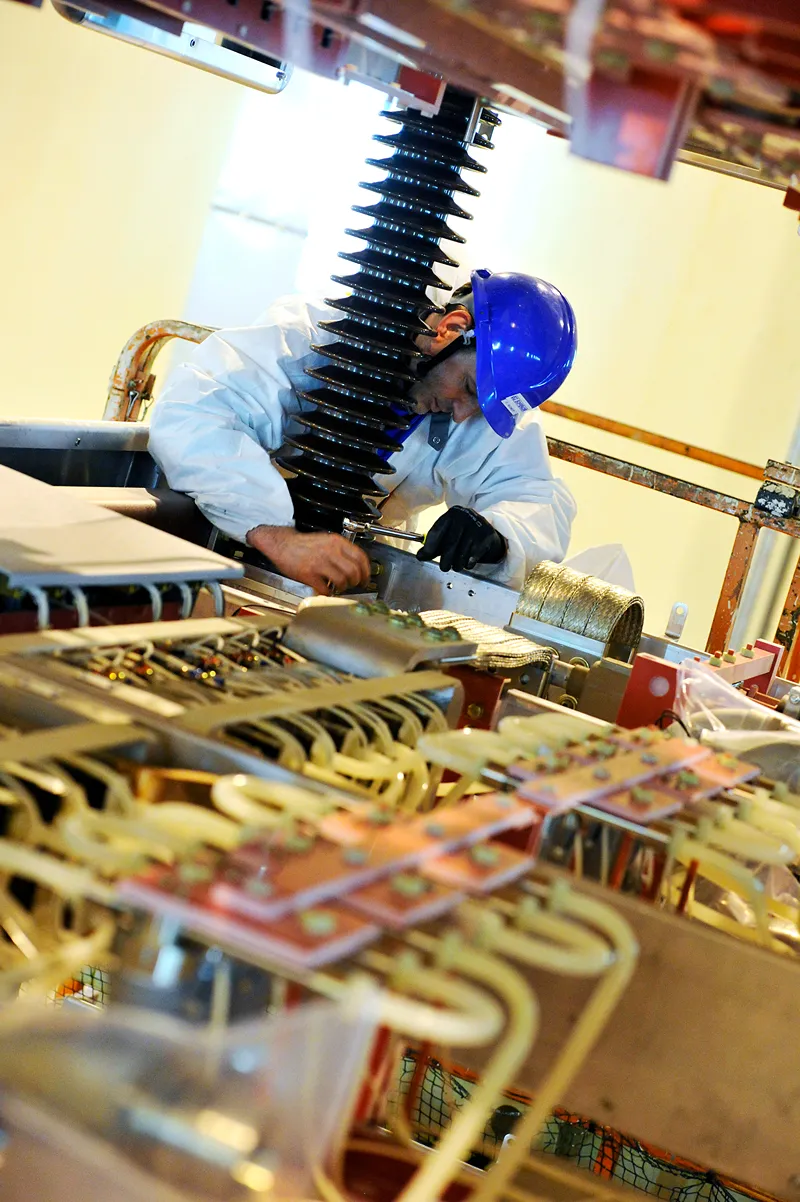 A photo of a person working on a complex machine