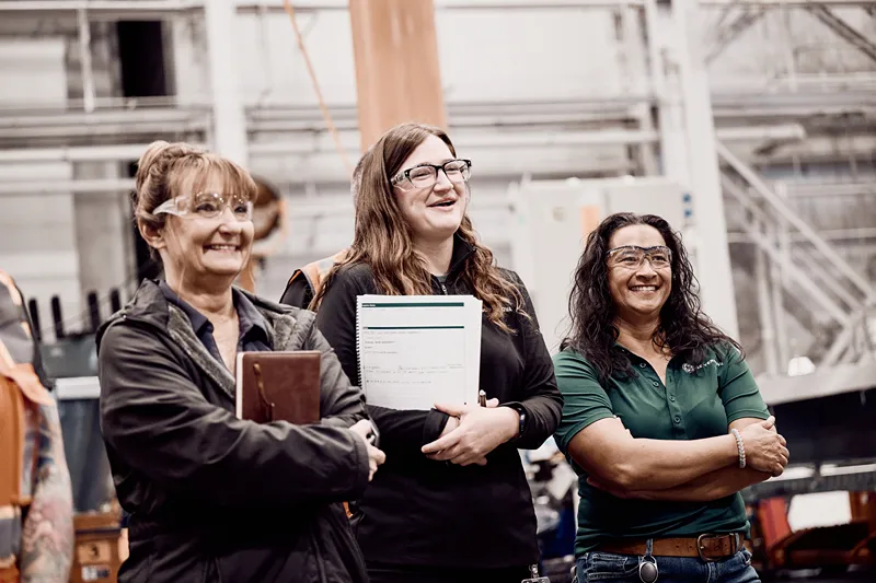 A group of people on a factory floor