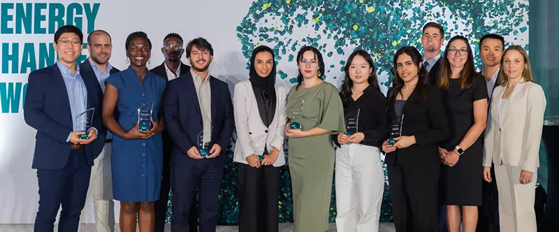 A group of people holding awards pose for a photograph
