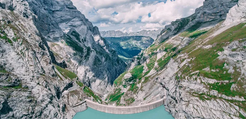 A photo of large dam and mountains