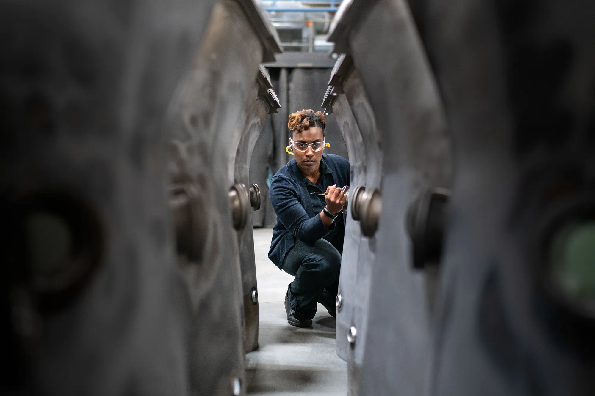 A photo of a woman working on machinery