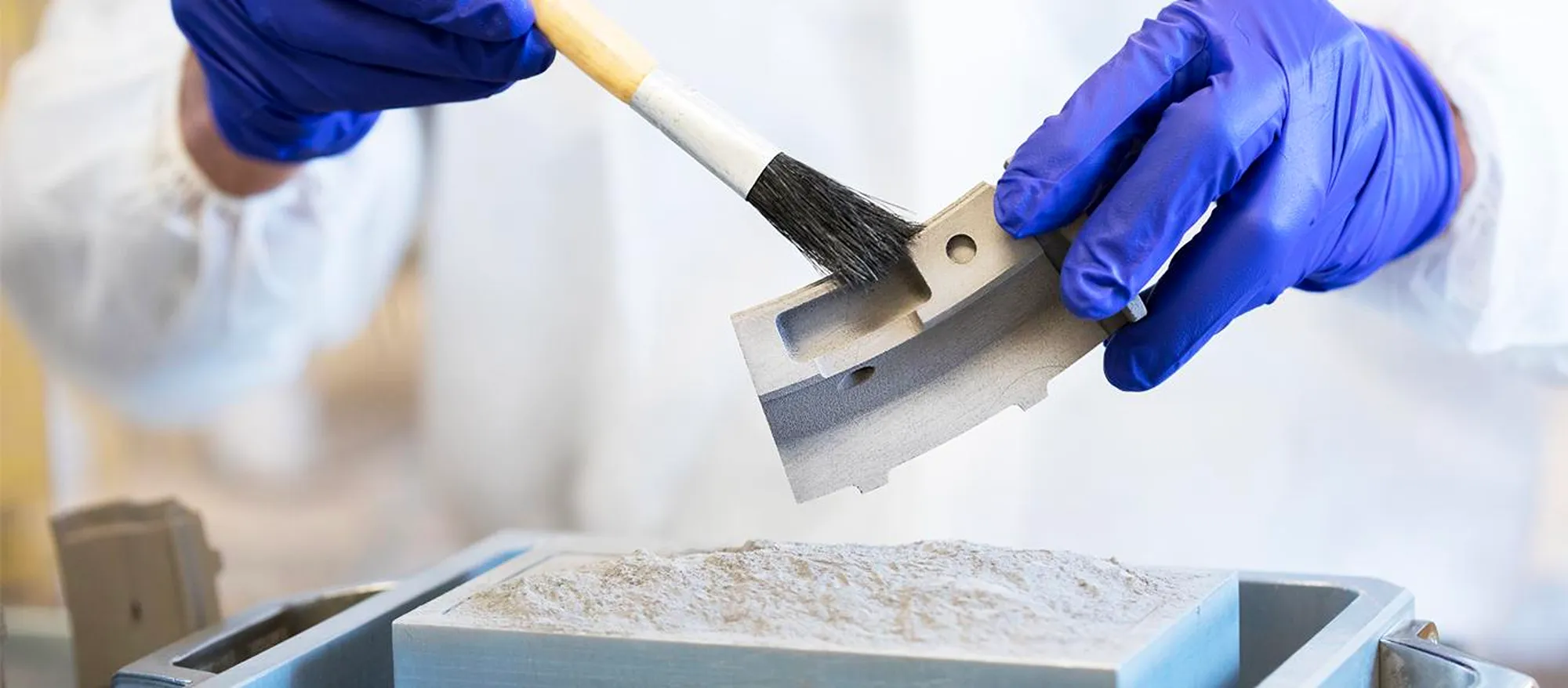 A person in working on a small piece of machinery