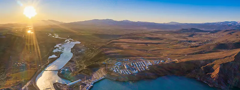 A photo of landscape next to a large body of water
