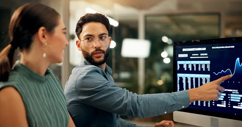A man pointing to his computer screen