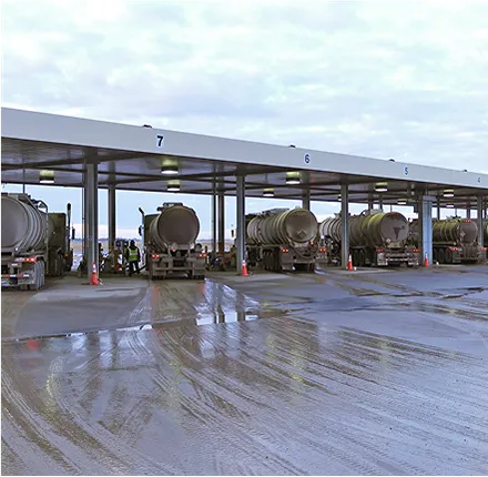 Photo of several trucks carrying large fuel containers