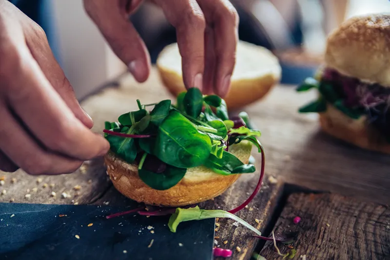 A person preparing a hamburger