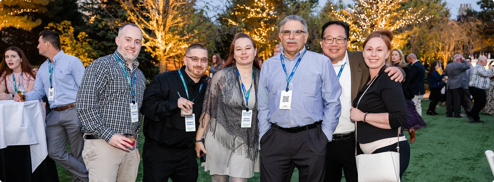 A group of people of six people gather for a photo outside taken outside