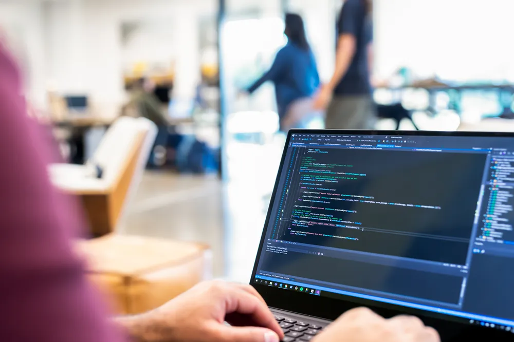 CarMax employee handing car keys to smiling customers outside the dealership, with a child sitting in the back seat.