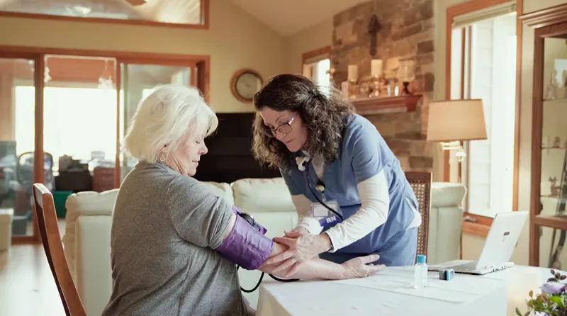 A photo of a nurse taking the blood pressure of an woman