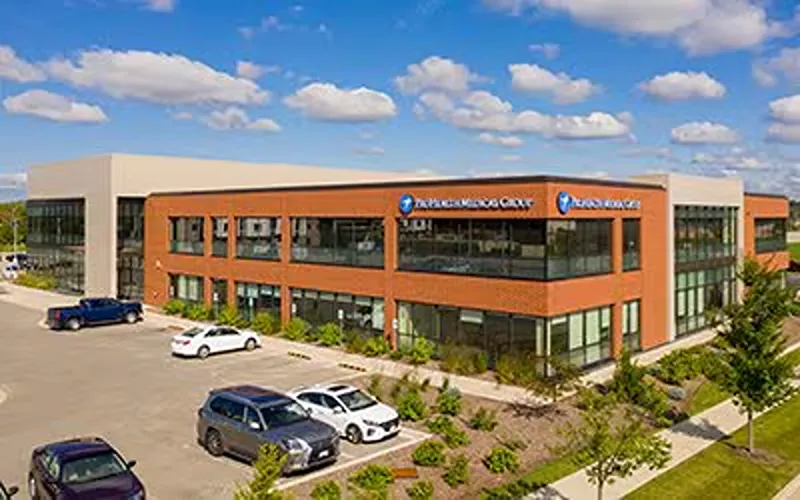 Exterior view of the ProHealth Medical Group Clinic in Brookfield, a modern two-story building with brick, large windows, a parking lot, and landscaping.