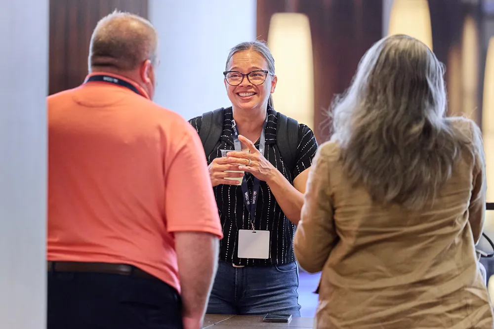 WGU faculty member engaging with students at a conference
