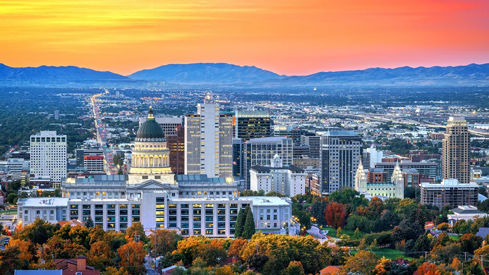 Salt Lake City skyline with mountains in the background at sunset