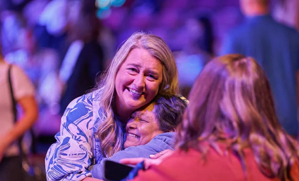 WGU team members sharing a warm moment at a company event