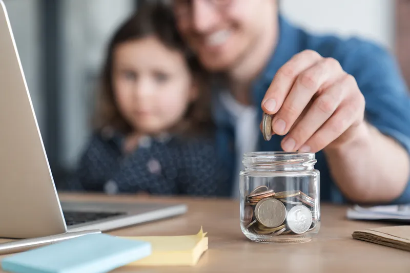 Person saving money in a jar