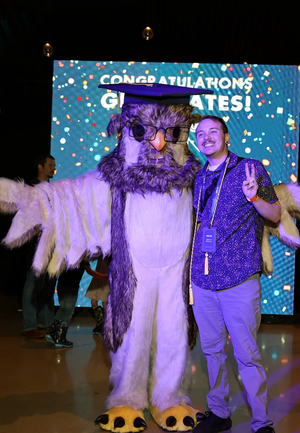 WGU team members celebrating at a company event with the university mascot