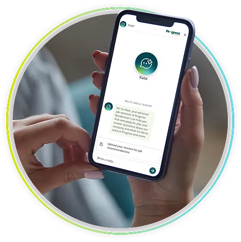Person holding a smartphone with a chat from Kate, a Progress Residential job assistant, helping candidates find jobs and join featured teams